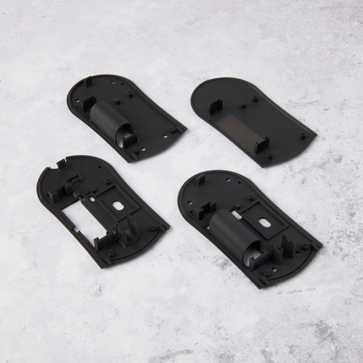 Four rapid prototyping iterations of a printed housing laid side by side