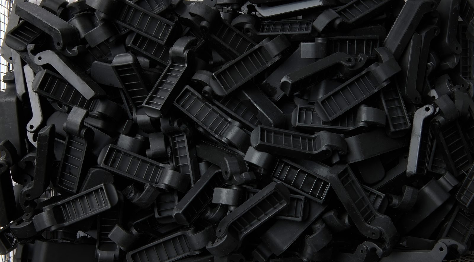 A production batch of identical black nylon parts