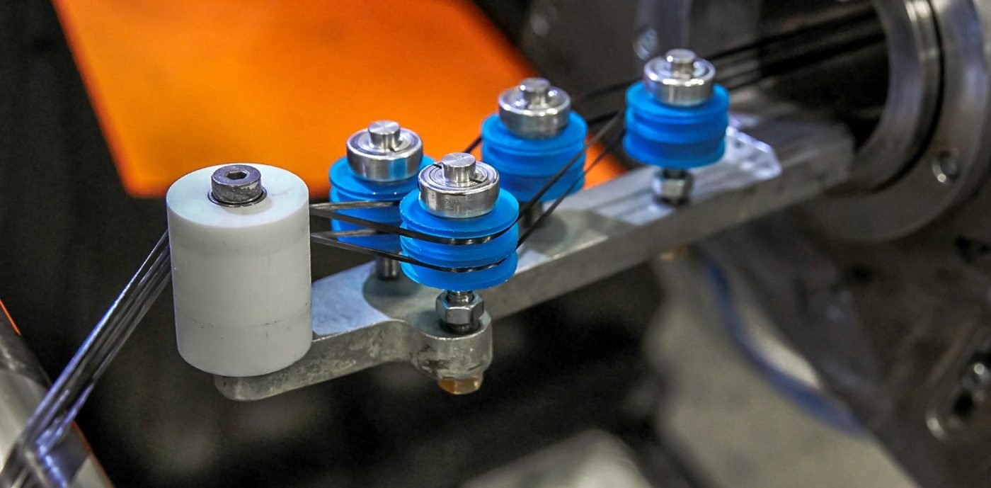 Blue printed fixtures holding parts on a production machine